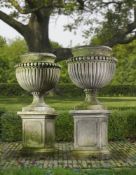 Ω A PAIR OF LARGE AND IMPRESSIVE CARVED LIMESTONE GARDEN UTNS ON PLINTHS IN IMPERIO TASTE