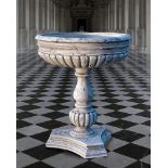 Ω A SCULPTED WHITE MARBLE PLANTER IN THE MANNER OF A CISTERN OR BASIN