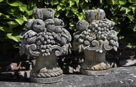 ‡ A PAIR OF SCULPTED LIMESTONE PIER FINIALS IN THE FORM OF BASKETS OF FRUITS