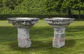 ‡ A PAIR OF CARVED LIMESTONE GARDEN TABLES