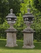 Ω A PAIR OF CARVED LIMESTONE GARDEN URNS