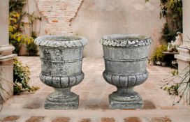 ‡ A PAIR OF CARVED LIMESTONE PLANTERS