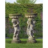 ‡ A PAIR OF SCULPTED LIMESTONE PEDESTAL PLANTERS