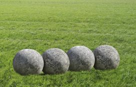 Ω A GROUP OF FOUR LIMESTONE ORNAMENTAL SPHERES