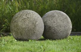 Ω A LARGE PAIR OF LIMESTONE ORNAMENTAL SPHERES