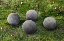 Ω A GROUP OF FOUR LIMESTONE ORNAMENTAL SPHERES