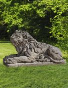 Ω A SCULPTED LIMESTONE MODEL OF A RECUMBENT LION