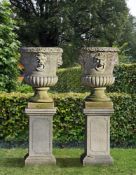 ‡ A PAIR OF CARVED LIMESTONE GARDEN URNS
