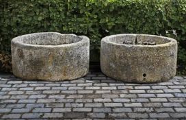 ‡ TWO SIMILAR CIRCULAR CARVED LIMESTONE TROUGHS