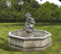 Ω A CONTINENTAL COMPOSITION STONE FIGURAL GARDEN FOUNTAIN