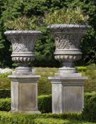 Ω A PAIR OF CARVED LIMESTONE URNS