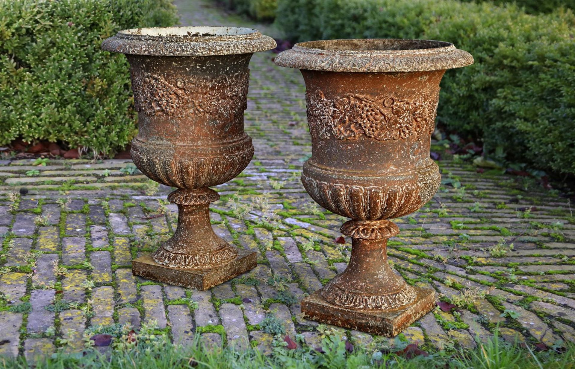 ‡ A PAIR OF CAST IRON PLANTERS