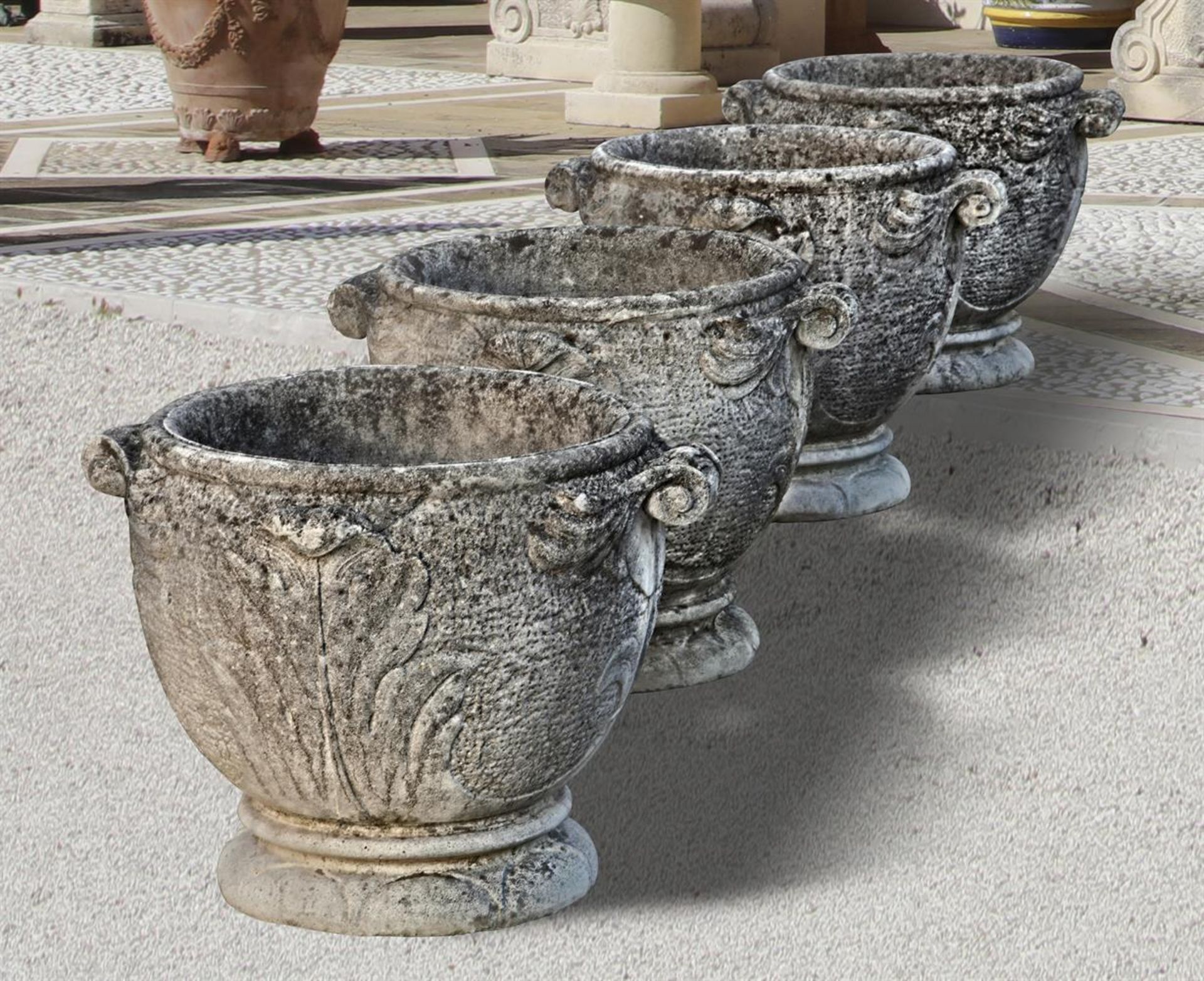 Ω A SET OF FOUR COMPOSITION STONE GARDEN PLANTERS