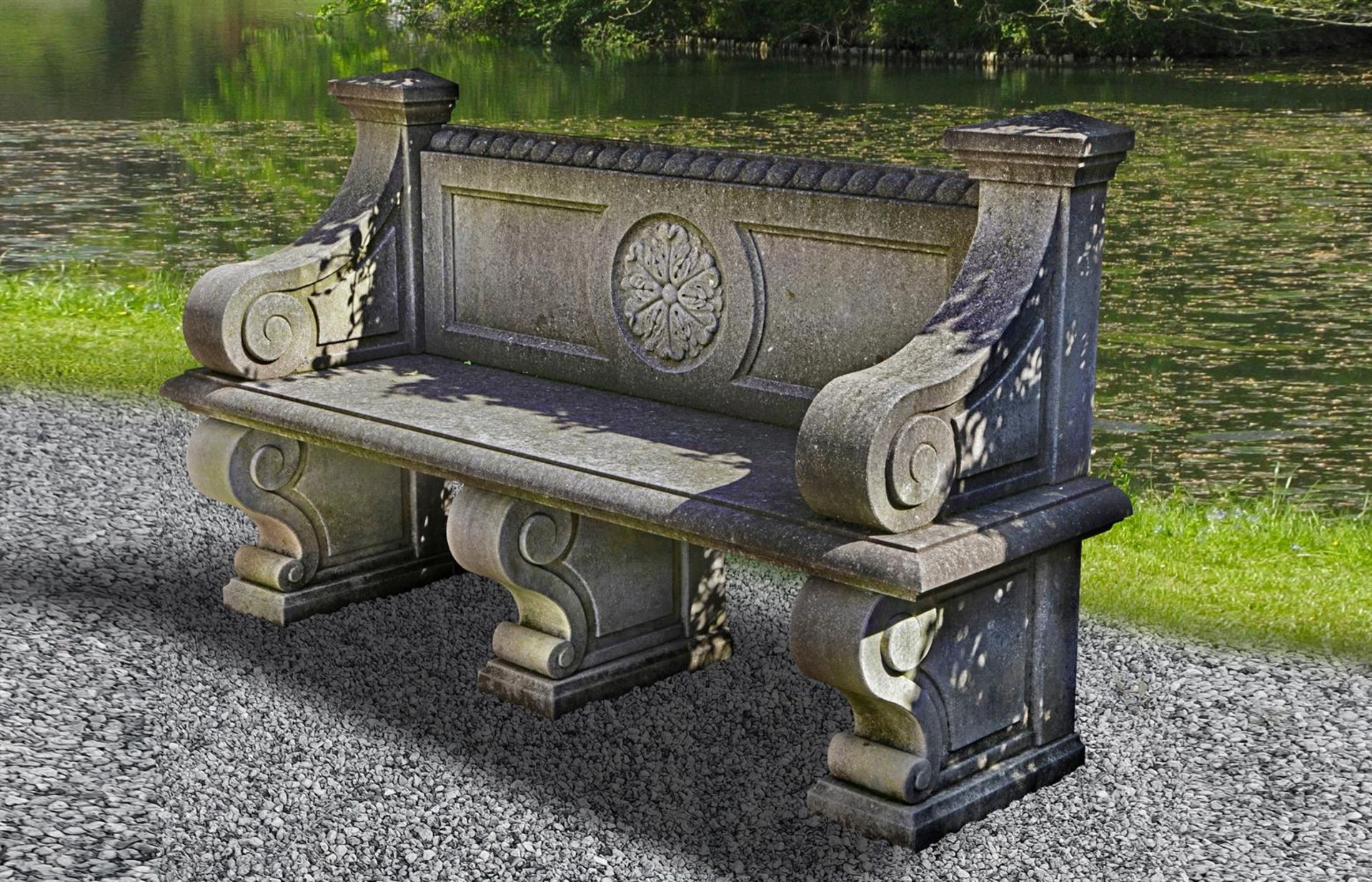 Ω A CARVED LIMESTONE GARDEN SEAT IN LATE 18TH CENTURY FRENCH STYLE