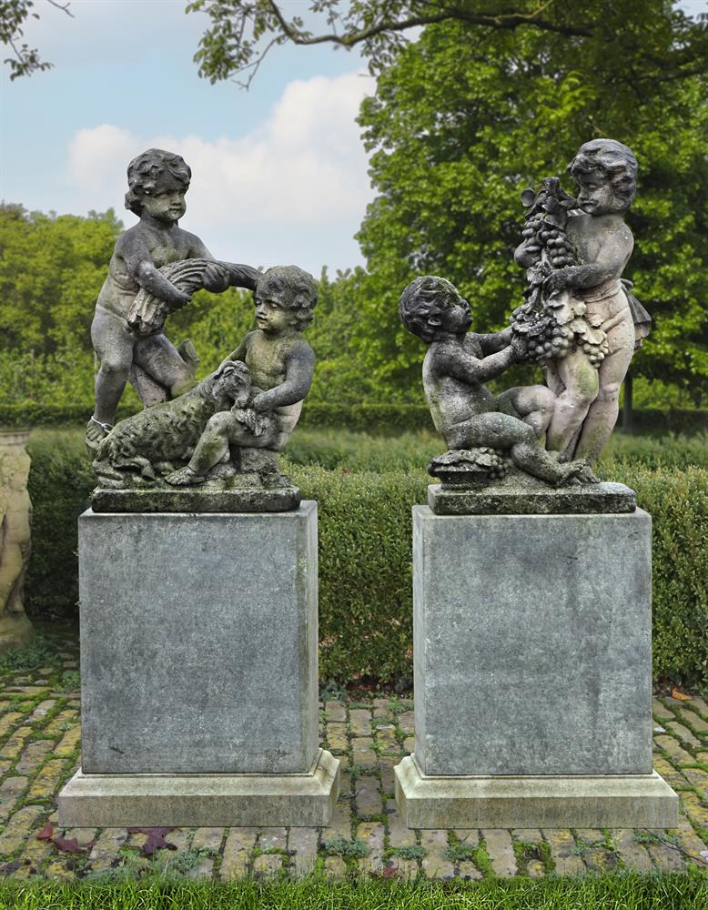 ‡ A PAIR OF SCULPTED LIMESTONE FIGURAL GROUPS OF PUTTI