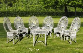 Ω A SUITE OF WHITE PAINTED WIREWORK GARDEN FURNITURE