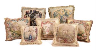 SEVEN LARGE CUSHIONS INCORPORATING 18TH CENTURY WOOLWORK AND LATER FABRIC