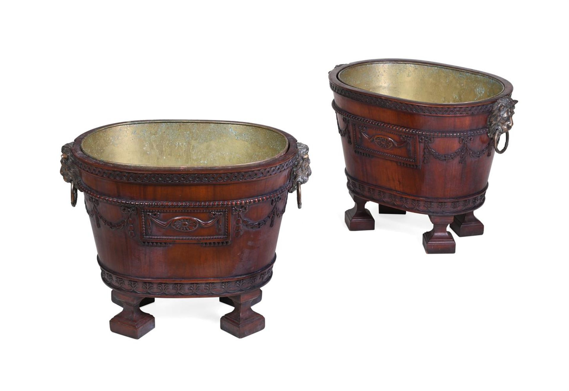 A PAIR OF MAHOGANY AND GILT METAL MOUNTED WINE COOLERS IN GEORGE III NEO-CLASSICAL TASTE