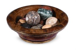 AN ASSORTMENT OF TWELVE MARBLE BALLS IN A BRASS BOUND WOODEN BOWL