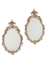 A PAIR OF ITALIAN BRONZE-PAINTED PLASTER OVAL MIRRORS