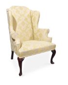 A WALNUT AND UPHOLSTERED WING ARMCHAIR, EARLY 18TH CENTURY AND LATER