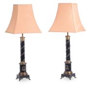 A PAIR OF EBONISED AND GILT METAL MOUNTED COLUMNAR LAMP BASES