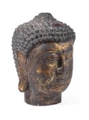 A CHINESE GILT AND LACQUERED WOOD HEAD OF BUDDHA