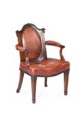 A VICTORIAN CARVED MAHOGANY AND LEATHER UPHOLSTERED OPEN ARMCHAIR IN GEORGIAN REVIVAL TASTE