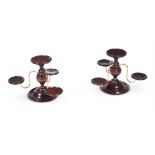 A PAIR OF MAHOGANY CENTRE PIECES WITH THREE BRASS ARMS ON A TURNED FOOT