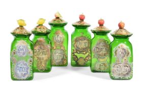 A SET OF SIX ITALIAN GREEN GLASS STORAGE JARS AND COVERS WITH FRUIT FINIALS