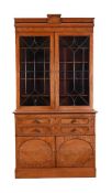 A REGENCY 'FLAME' MAHOGANY AND EBONISED BUREAU BOOKCASE IN THE MANNER OF GILLOWS