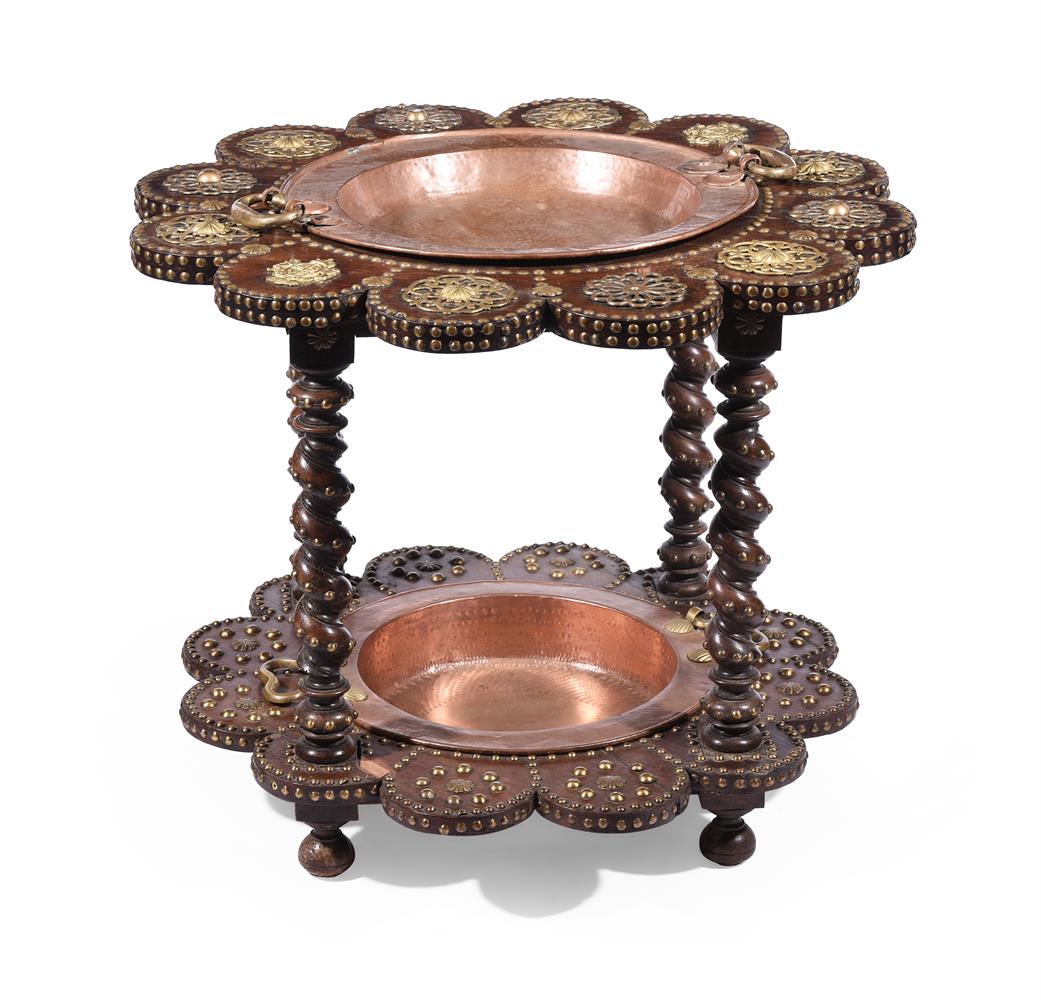 A WALNUT, BRASS MOUNTED AND STUDDED TWO TIER SCALLOPED STAND, INSET WITH TWO COPPER BOWLS