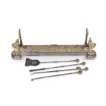 A MID VICTORIAN BRASS AND STEEL FIREPLACE FENDER AND A SET OF THREE FIRE-IRONS