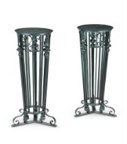 A PAIR OF CAST IRON AND GREEN PAINTED TORCHERE STANDS IN VICTORIAN STYLE