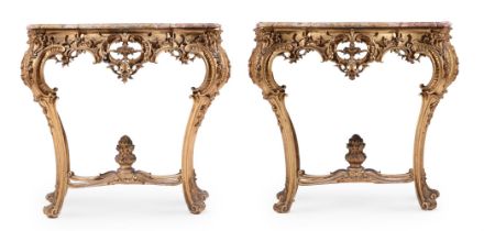 A PAIR OF FRENCH CARVED GILTWOOD SERPENTINE CONSOLE TABLES IN LOUIS XV STYLE