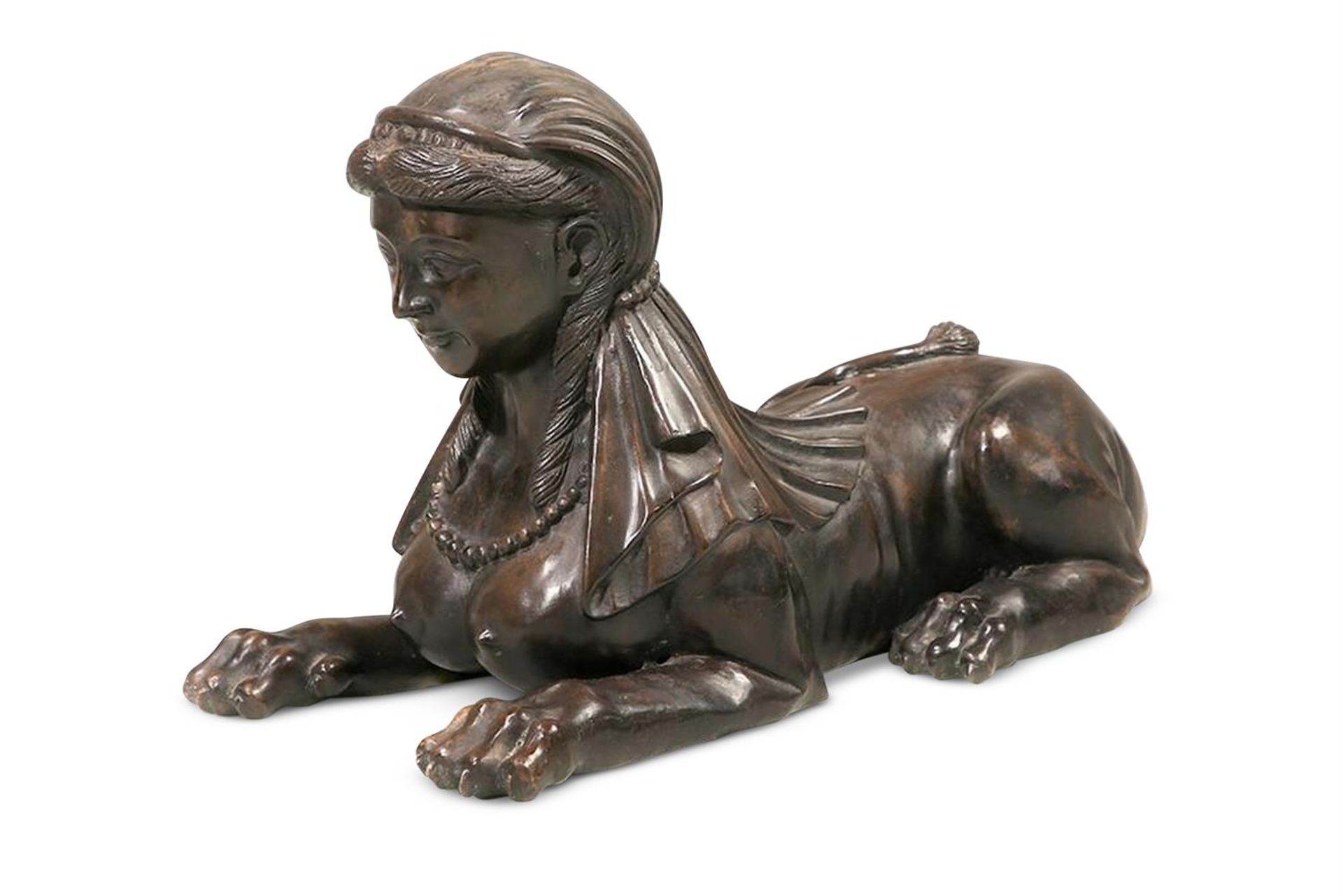 A BRONZED METAL MODEL OF A A RECUMBENT SPHINX, LATE 20TH CENTURY