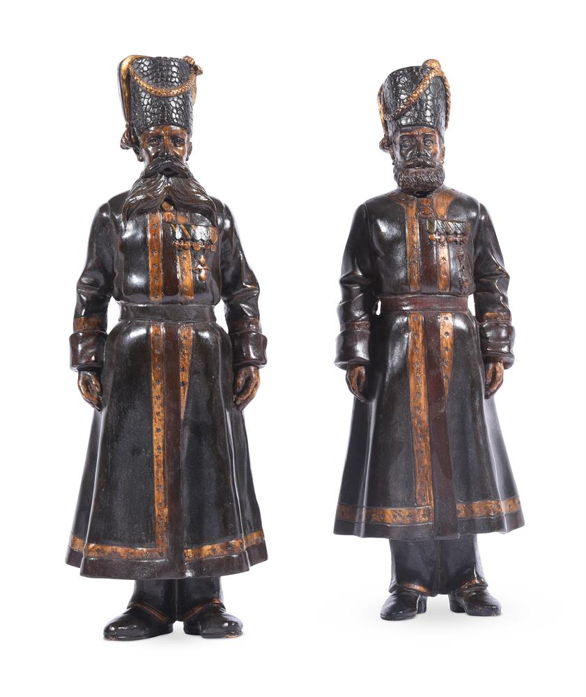 A PAIR OF RUSSIAN BRONZED AND GILT METAL MODELS OF COSSACK SOLDIERS