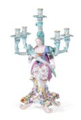 A MEISSEN FIVE BRANCH FIGURAL AND FLOWER ENCRUSTED TABLE CANDELABRUM