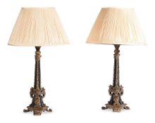 A PAIR OF EBONIZED AND GILT METAL MOUNTED LAMP BASES