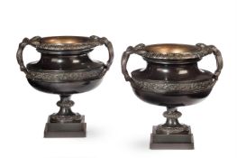 A PAIR OF BRONZE NEOCLASSIC TWIN HANDLED PEDESTAL URNS 19TH CENTURY