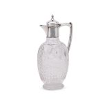 AN EDWARDIAN SILVER MOUNTED AND CUT GLASS CLARET JUG