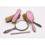 A SILVER MOUNTED AND PINK ENAMEL SIX PIECE DRESSING TABLE SET