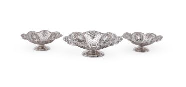 A MATCHED SET OF THREE VICTORIAN SILVER SHAPED CIRCULAR PIERCED PEDESTAL DISHES