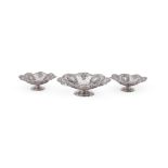 A MATCHED SET OF THREE VICTORIAN SILVER SHAPED CIRCULAR PIERCED PEDESTAL DISHES