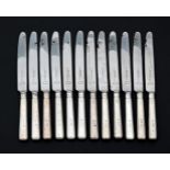 A SET OF TWELVE SILVER HANDLED TABLE KNIVES