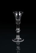 A BALUSTER WINE GLASSMID 18TH CENTURYThe bell bowl with a solid lower section with bead inclusion