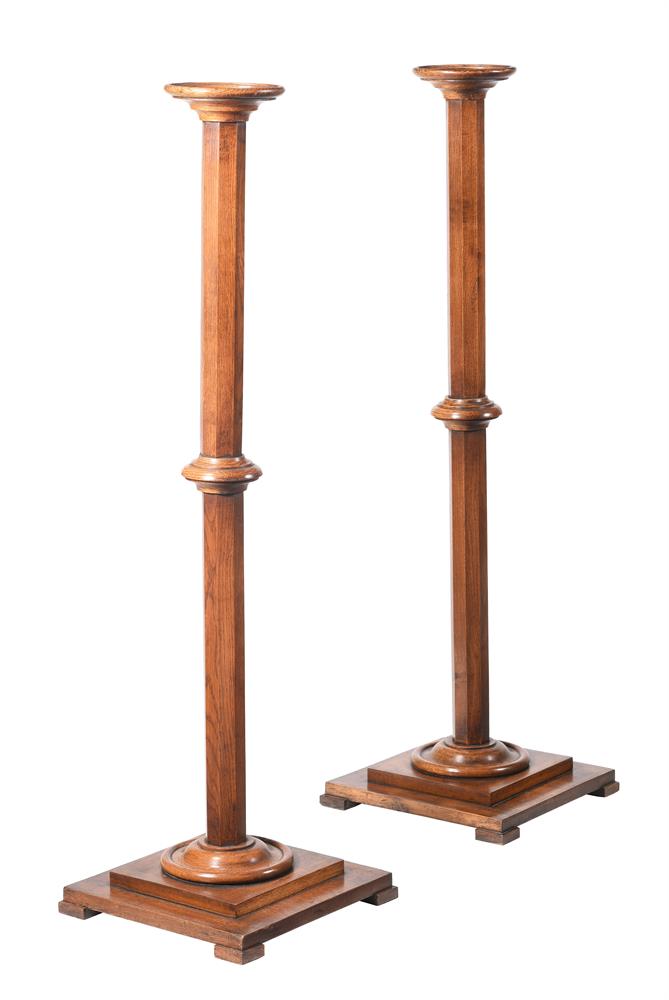 A PAIR OF VICTORIAN OAK TORCHERE STANDS