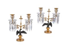 A PAIR OF REGENCY PATINATED AND GILT METAL TABLE TWIN BRANCH CANDELABRA