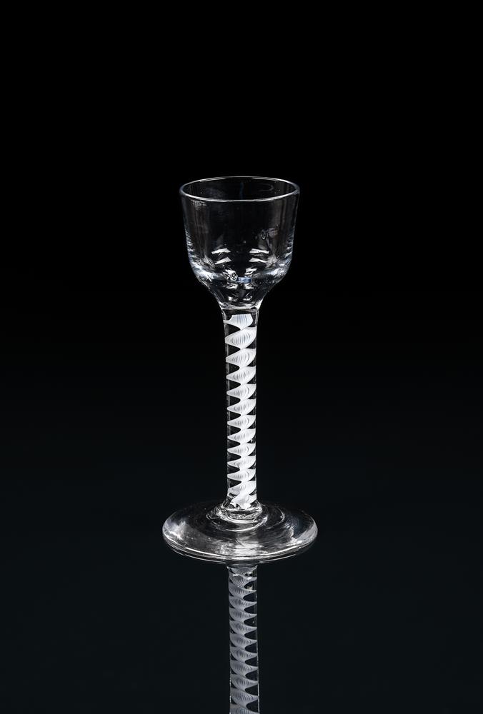 AN OPAQUE-TWIST CORDIAL GLASSTHIRD QUARTER 18TH CENTURYThe ogee bowl supported on a 'corkscrew' st