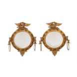 A PAIR OF GILTWOOD CONVEX WALL MIRRORS IN REGENCY STYLE